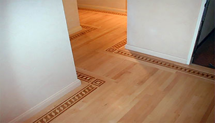 Installing wood over cement is a unique challenge. Using solid maple set off by a custom border, Craftcare brought old-world charm to this high rise condo.